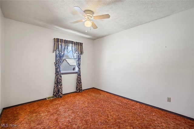 spare room featuring ceiling fan, a textured ceiling, and carpet