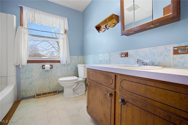 bathroom featuring vanity, toilet, and tile walls