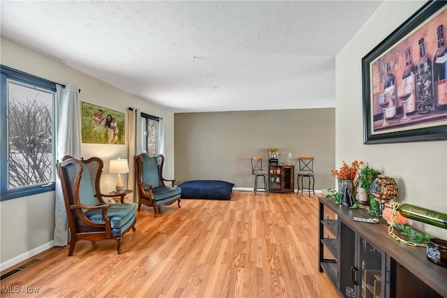 living area featuring hardwood / wood-style flooring and a textured ceiling