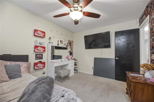 bedroom featuring a textured ceiling, ceiling fan, and carpet flooring