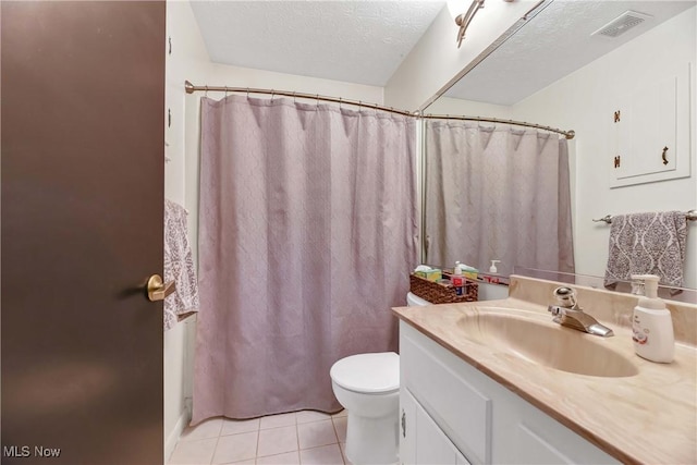 bathroom with curtained shower, tile patterned flooring, vanity, toilet, and a textured ceiling