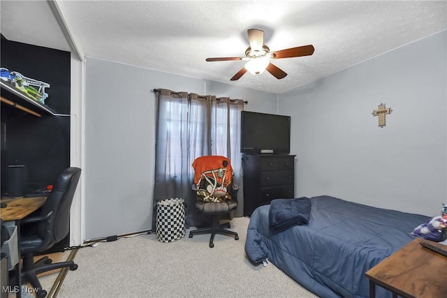 carpeted bedroom featuring a textured ceiling and ceiling fan