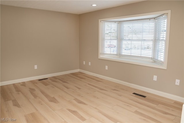 empty room with light hardwood / wood-style flooring