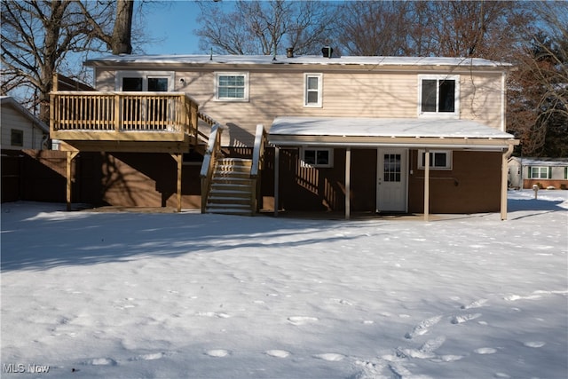 snow covered property featuring a deck