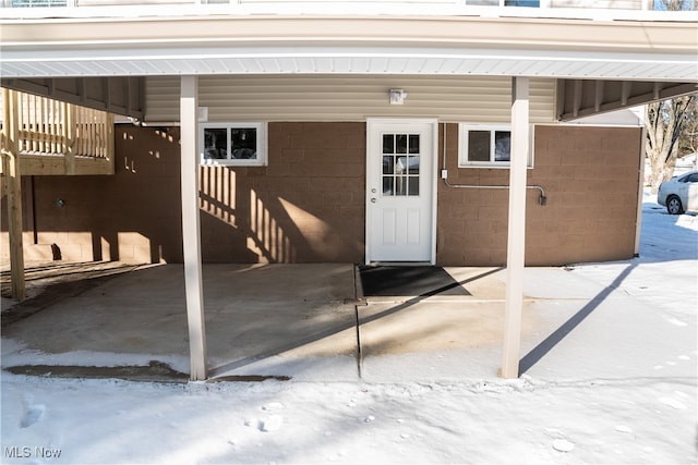 view of snow covered property entrance