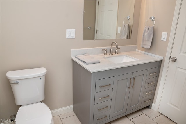 bathroom featuring vanity, tile patterned floors, and toilet