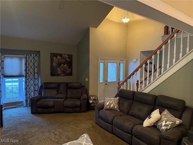 carpeted living room with high vaulted ceiling