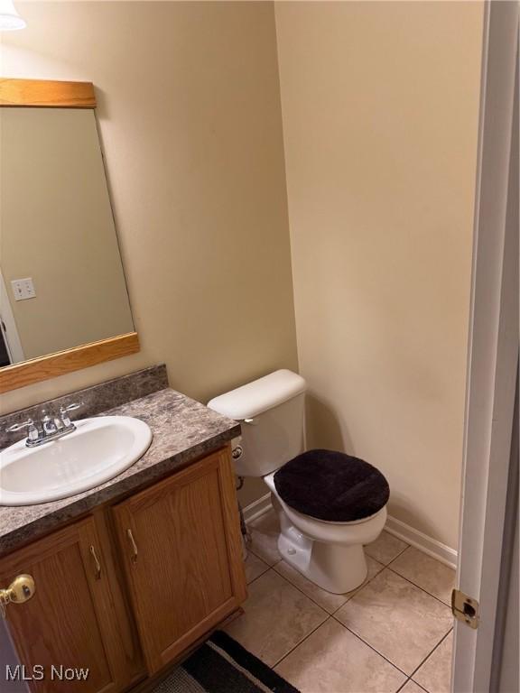 bathroom with vanity, tile patterned floors, and toilet