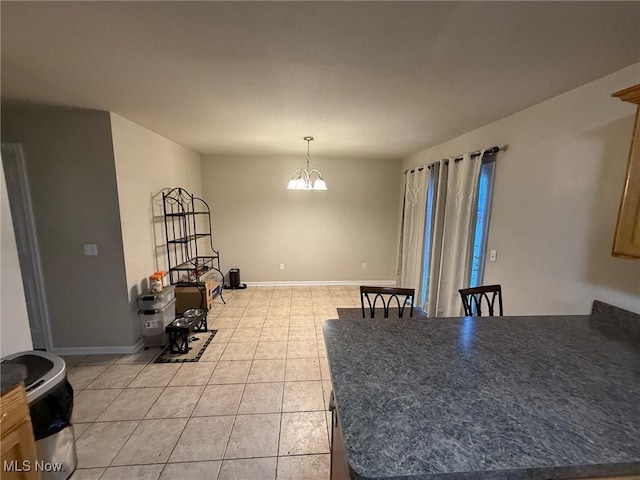 dining space with light tile patterned flooring and an inviting chandelier