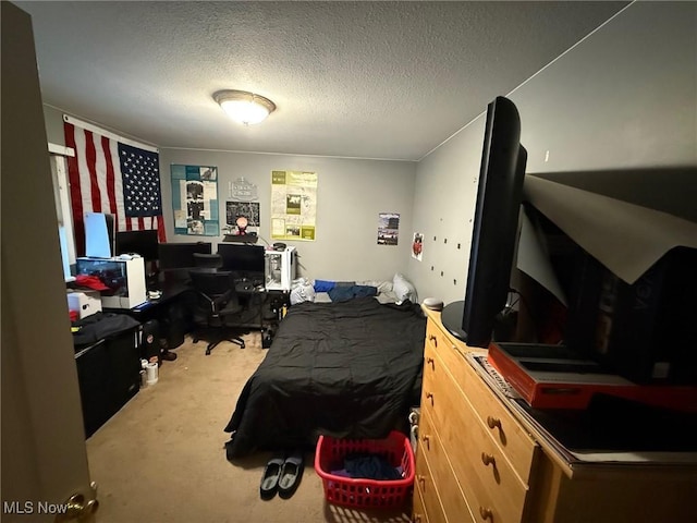 bedroom with carpet floors and a textured ceiling