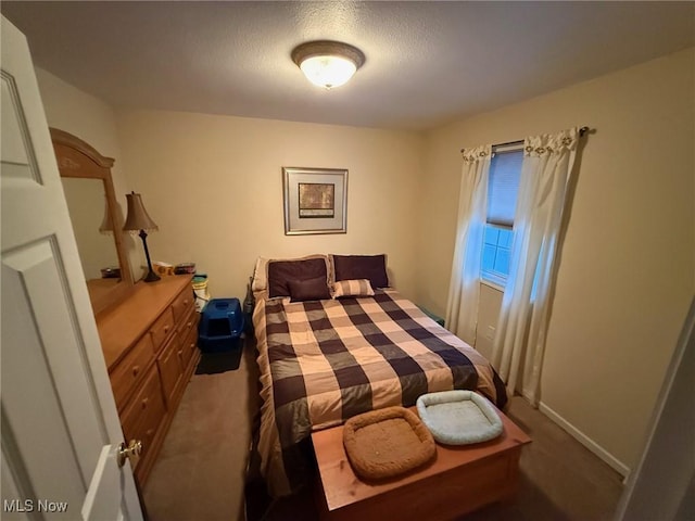 carpeted bedroom with a textured ceiling