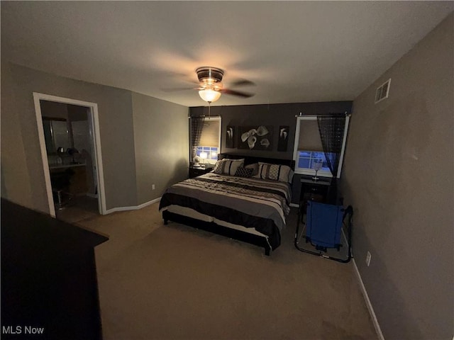 carpeted bedroom featuring ceiling fan and ensuite bath