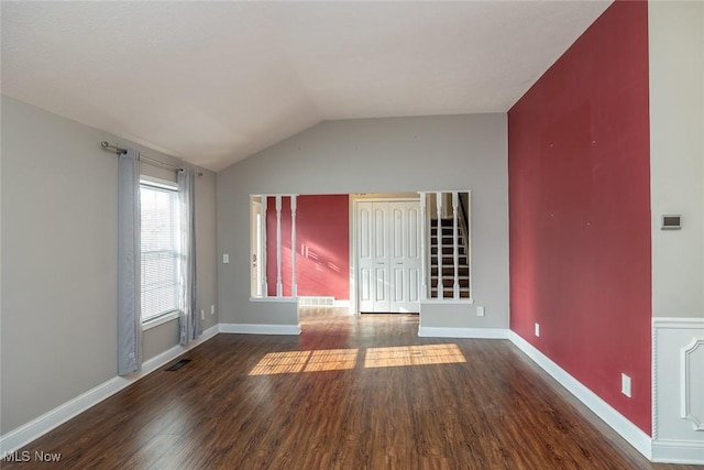 interior space featuring vaulted ceiling and dark hardwood / wood-style floors