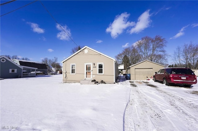 view of front of house featuring a garage and an outdoor structure