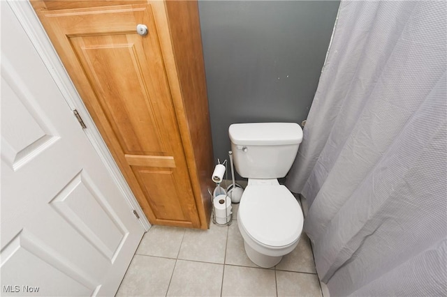 bathroom with tile patterned flooring and toilet