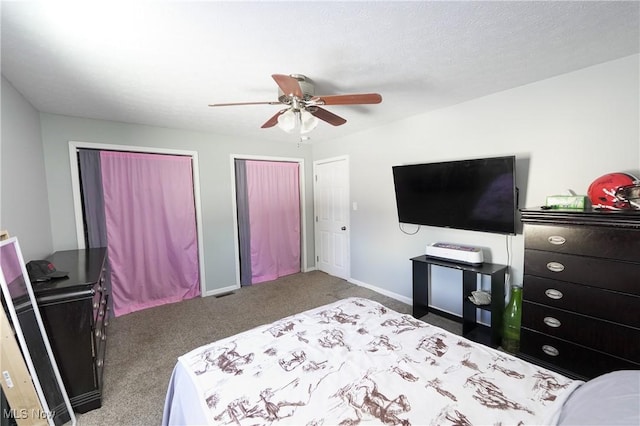 bedroom with multiple closets, carpet flooring, and ceiling fan