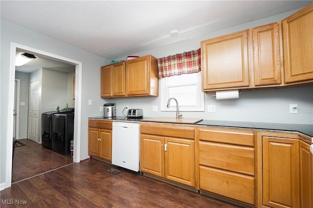 kitchen with dark hardwood / wood-style floors, separate washer and dryer, sink, and white dishwasher