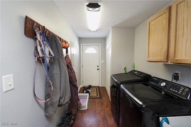 laundry area with dark wood-type flooring, washer and clothes dryer, cabinets, and a textured ceiling