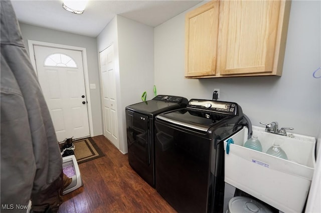 laundry area with cabinets, washer and dryer, sink, and dark hardwood / wood-style flooring