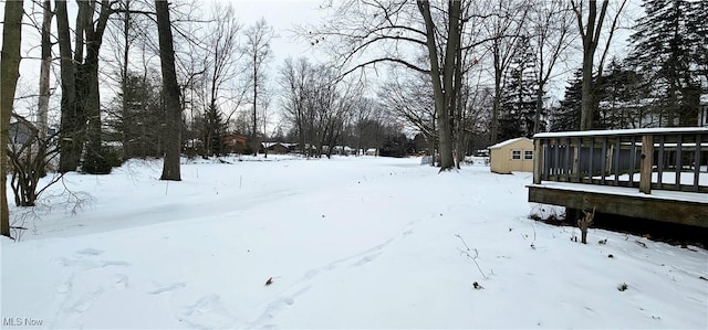 yard covered in snow with a sunroom