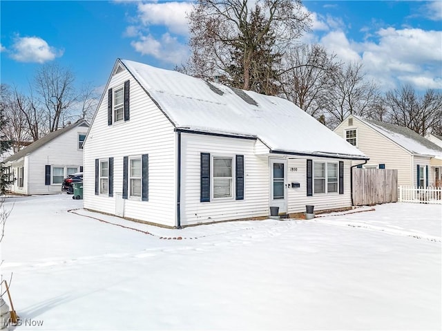 view of snow covered rear of property