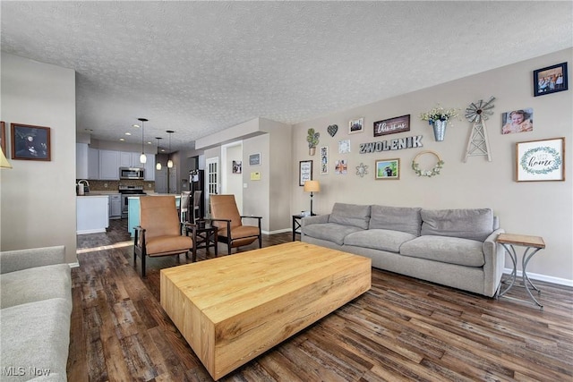 living room with dark hardwood / wood-style floors, sink, and a textured ceiling