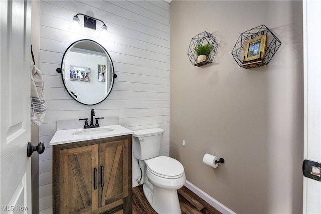 bathroom featuring vanity, hardwood / wood-style floors, and toilet