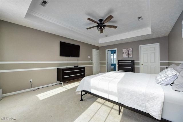 carpeted bedroom with crown molding, ceiling fan, a raised ceiling, and a textured ceiling