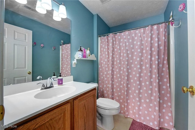 bathroom featuring tile patterned floors, vanity, toilet, and a textured ceiling