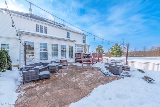 snow covered house featuring a deck