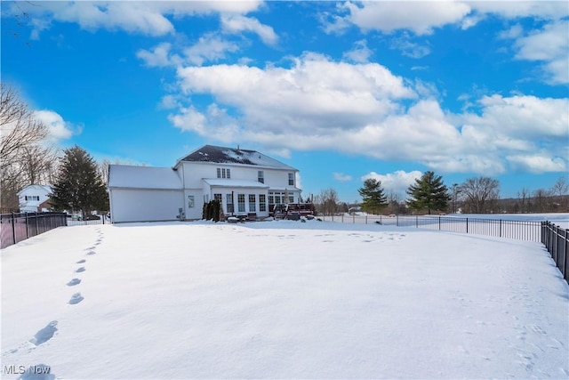 view of snow covered rear of property