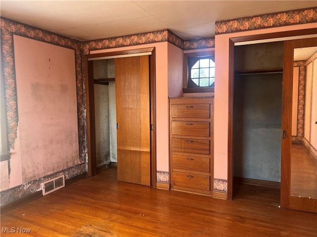 unfurnished bedroom featuring hardwood / wood-style floors and a closet