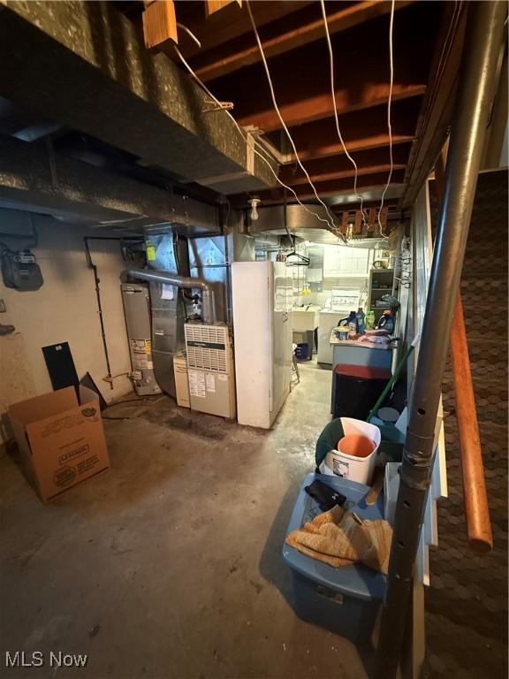 basement featuring sink and water heater