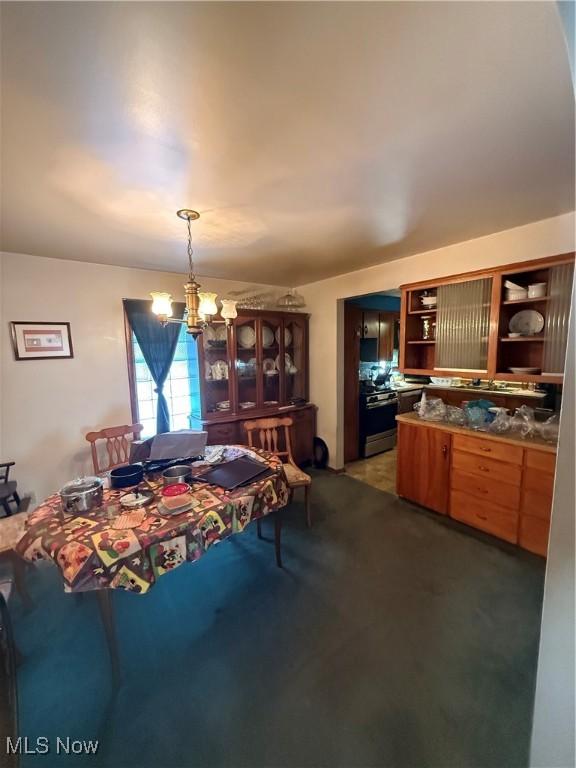 carpeted dining area with a notable chandelier