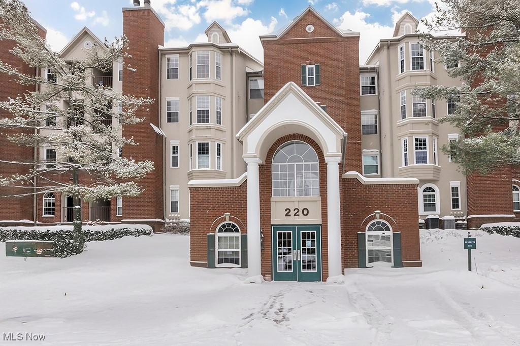 snow covered property featuring central AC unit