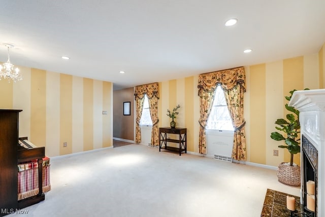 sitting room with carpet flooring and a chandelier