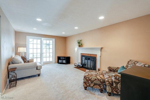 carpeted living room featuring a fireplace