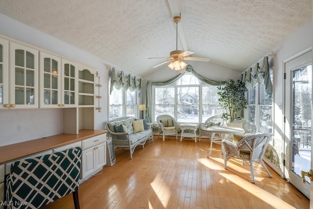 sunroom with vaulted ceiling and ceiling fan