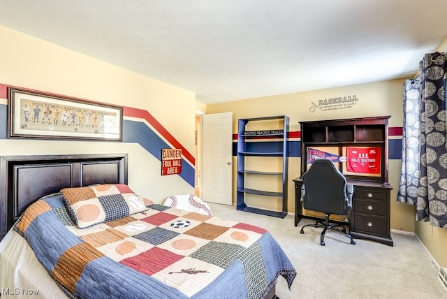 bedroom with light carpet and a textured ceiling