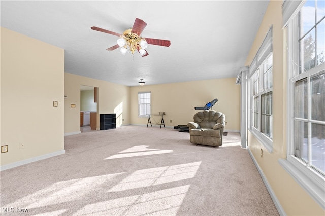 unfurnished room featuring ceiling fan and light colored carpet