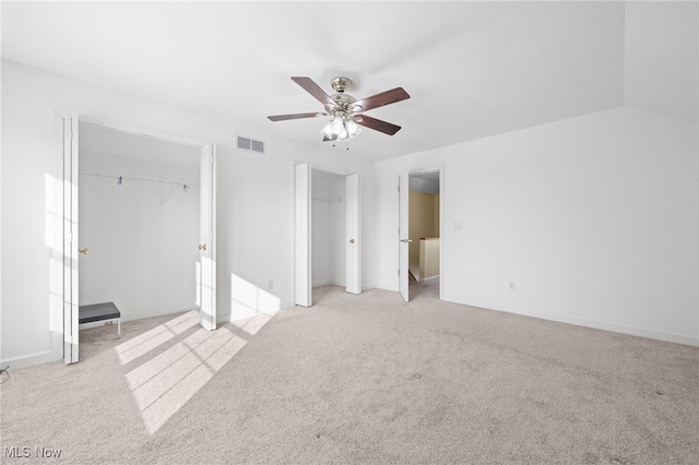 unfurnished bedroom with vaulted ceiling, light carpet, and ceiling fan