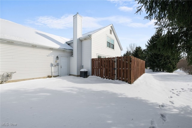 snow covered property featuring a garage