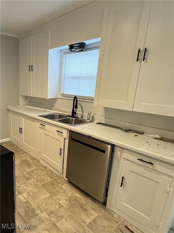 kitchen with white cabinetry, dishwasher, and sink