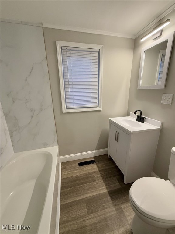 full bathroom with vanity, wood-type flooring, ornamental molding, shower / washtub combination, and toilet