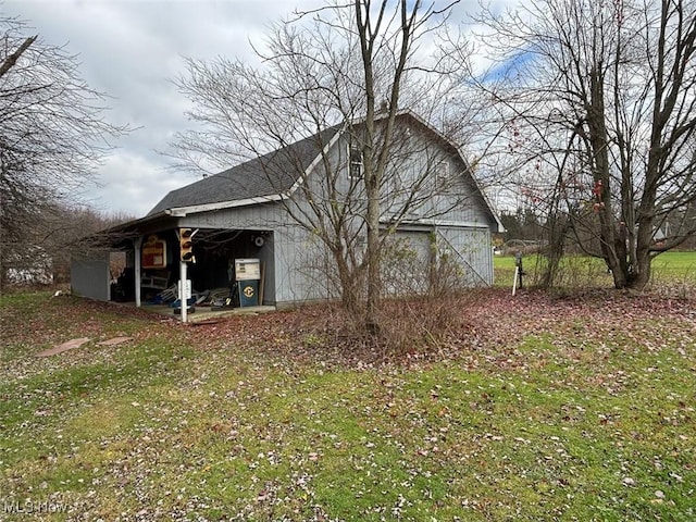 view of property exterior with an outbuilding and a lawn