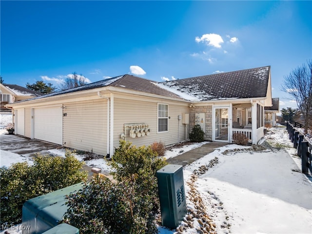 view of front of home featuring a porch and a garage