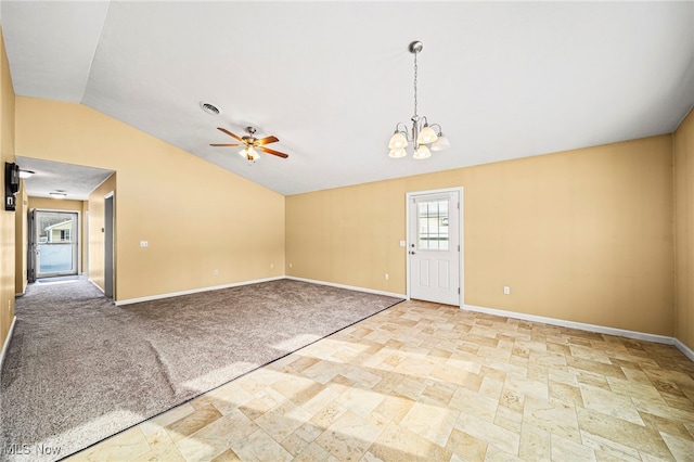 spare room with ceiling fan with notable chandelier, lofted ceiling, and light colored carpet