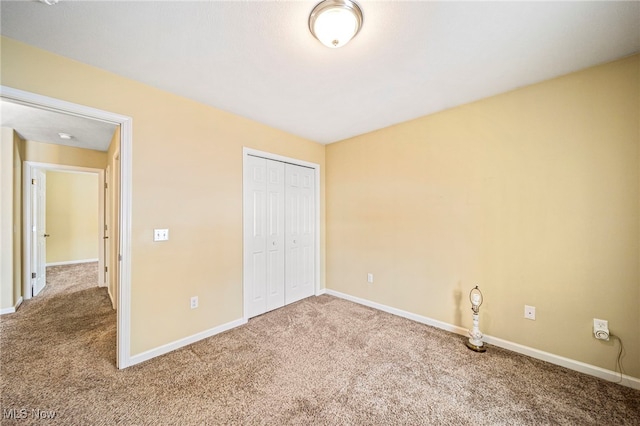 unfurnished bedroom with carpet and a closet