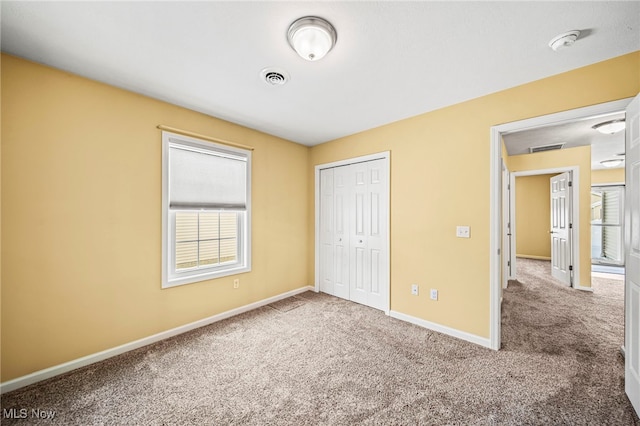 unfurnished bedroom with carpet flooring and a closet