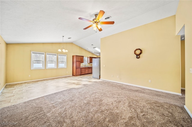 unfurnished living room with light carpet, sink, ceiling fan with notable chandelier, and lofted ceiling